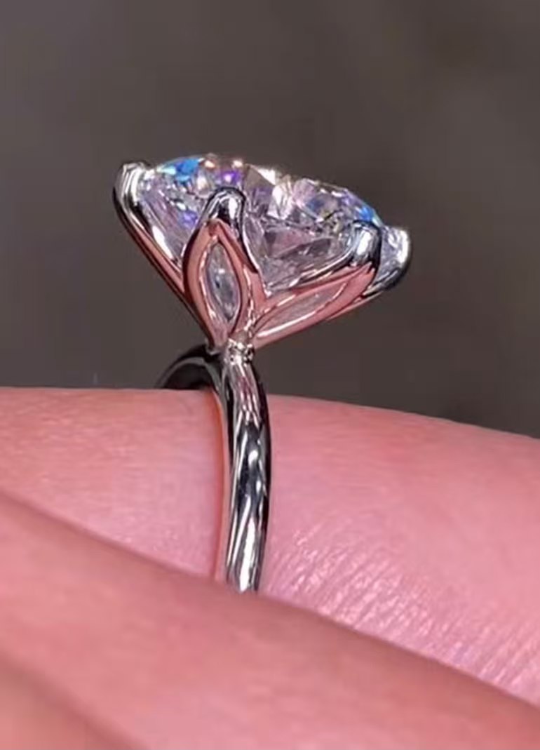 A slim, delicate band set with a single 3-carat six-prong diamond.